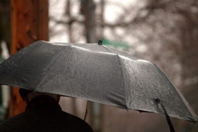 a person holding an umbrella in the rain
